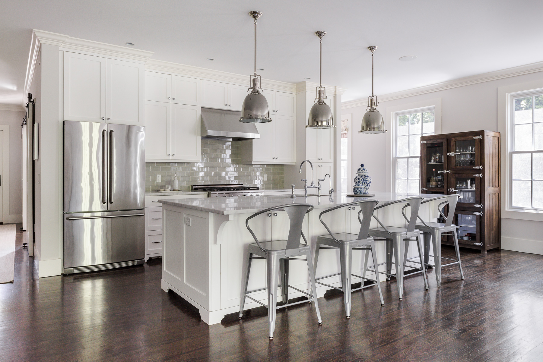 White kitchen with island and pendant lighting